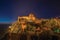 Walls and tower of Castle over rocky cliff at dusk in Marvao