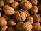 Walnut background, scattered pile of walnuts background
