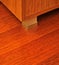 Walnut cabinet and corner detail on mahogany parquet in luxury house