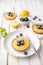 Walnut crust Tartlet with lemon curd filling, topped with fresh blueberries and sprinkled with powdered sugar