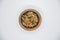 Walnut kernel halves, in a wooden bowl on white background. Close-up