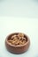 Walnut kernel halves, in a wooden bowl on white background. Close-up