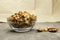 Walnut kernels in a bowl on a gray background