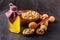 Walnut oil from walnut kernels in a bottle , walnut shells around it and whole walnuts on the wooden table