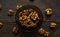 Walnut in a smale plate with scattered shelled nuts and whole nut which standing on a wooden vintage table. Walnuts is a