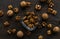 Walnut in a smale plate with scattered shelled nuts and whole nut which standing on a wooden vintage table. Walnuts is a