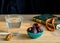 Walnut, turquoise piala with dates, glass of clear water, rosary and book of Quran on table First meal, Muslim fast Eid al, Uraza