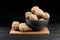 Walnut and walnut kernels on the plate on rustic wooden black background.