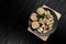 Walnut and walnut kernels on the plate on rustic wooden black background.