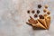 Walnuts, anise and cinnamon sticks in wafer cones. Close-up, top view, flat lay on concrete gray background