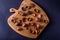 Walnuts and dried fruits on a wooden board, top view