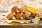 Walnuts and fallen walnut leaves on an old rustic wooden table