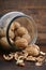 Walnuts in glass jar on wood table.