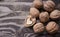 Walnuts on a grey textured wooden table. Assortment of nuts isolated on rustic old wooden background and splintered walnut with he