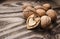Walnuts on a grey textured wooden table. Assortment of nuts on rustic old wooden background and splintered walnut with he
