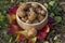 Walnuts in hard shells, pile of dry ripened fruits in the grass on colorful leaves in wooden bowl