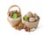 Walnuts and hazelnuts of different varieties lie in wooden saucers and baskets on a white isolated background. Nearby