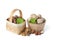 Walnuts and hazelnuts of different varieties lie in wooden saucers and baskets on a white isolated background. Nearby