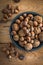 Walnuts and hazelnuts over wooden board