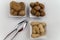 Walnuts, hazelnuts and peanuts in three bowls