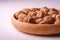Walnuts heap food in wooden bowl on white background