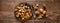 Walnuts. Kernels and whole nuts on wooden rustic table, banner closeup, top view