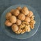 Walnuts lie in a glass dish. Whole and split. Healthy food.