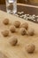 Walnuts on a light board and pumpkin seeds on a dark table. Glass of water. The rays of the sun on the table. Low calorie diet