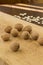 Walnuts on a light board and pumpkin seeds on a dark table. The rays of the sun on the table. Low calorie diet concept