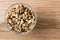 Walnuts peeled in a bowl on a wooden surface