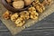 Walnuts on rustic table in clay bowl. Walnut kernels.