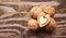 Walnuts on a textured wooden table. Assortment of nuts isolated on rustic old wooden background and splintered walnut with heart-s