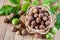 Walnuts in a wicker plate on a wooden table