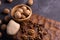 Walnuts in wooden bowl on wooden carved board. Walnuts, stone and cutting board. Healthy nuts and seeds composition.