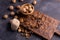 Walnuts in wooden bowl on wooden carved board. Walnuts, stone and cutting board. Healthy nuts and seeds composition.