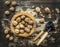 Walnuts in a wooden bowl on a wooden rustic background with tongs for cracking nuts,top view