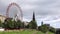 Walter Scott Monument in Edinburgh and ferris wheel in a summer day, Scotland, UK