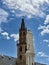 Walther Von der Vogelweide monument and bell tower of the Cathedral of Bolzano. Italy