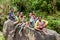 Wamena, Indonesia - January 10, 2010: People of the Dani tribe in a usual dress sitting on the big stone. Baliem Valley Papua