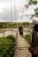 Wamena, Indonesia - January 9, 2010: Three local Dani women bear the load across the bridge, Papua New Guinea