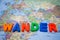 wander written with toy blocks on a world map