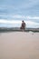 Wanderer walking in the desert. Young man standing in white sand dunes