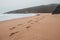 Wandering along the Fisherman Trail in the Algarve region of southwestern Portugal. Human footprints in the sandy surface