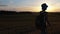 Wanderlust Adventure: Teen Boy Walking Across Summer Field at Sunset with Backpack, Steadicam Shot