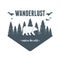 Wanderlust label with forest scene and grizzly bear