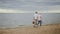 Wanderlust mature couple enjoying walk on ocean shoreline.