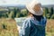 Wanderlust and travel concept. Stylish hipster girl holding map and compass, traveling in sunny mountains. Woman in hat exploring