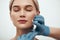 Wanna be perfect. Portrait of young pretty woman keeping eyes closed while doctors hand in blue medical gloves making an