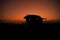 War Concept. Armored vehicle silhouette fighting scene on war fog sky background. American tank at sunset