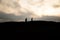 War Concept. Military silhouettes fighting scene on war fog sky background, World War German Tanks Silhouettes Below Cloudy